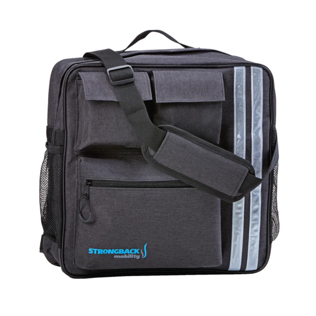 The Strongback Travel Storage Bag For Mobility Aids is a dark gray square bag with front pockets, mesh side pockets, a padded shoulder strap, and two vertical reflective stripes. The blue Strongback Mobility logo appears on the lower left pocket.